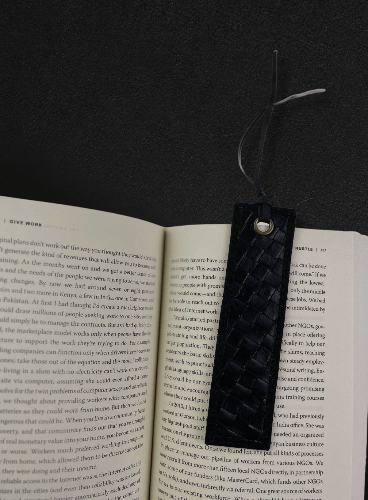 Close-up of a black woven leather bookmark in a book
