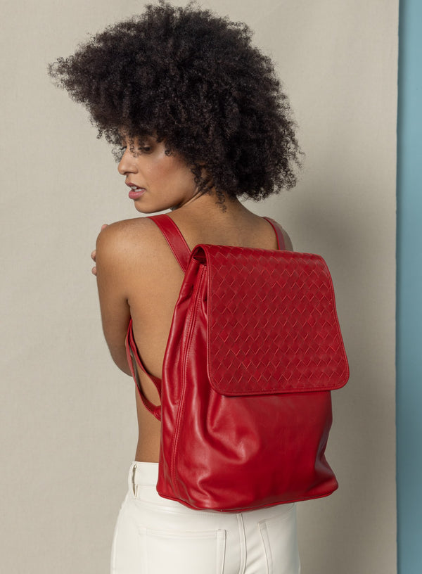 woven backpack in red from womens bags collection showcased by model wearing it.