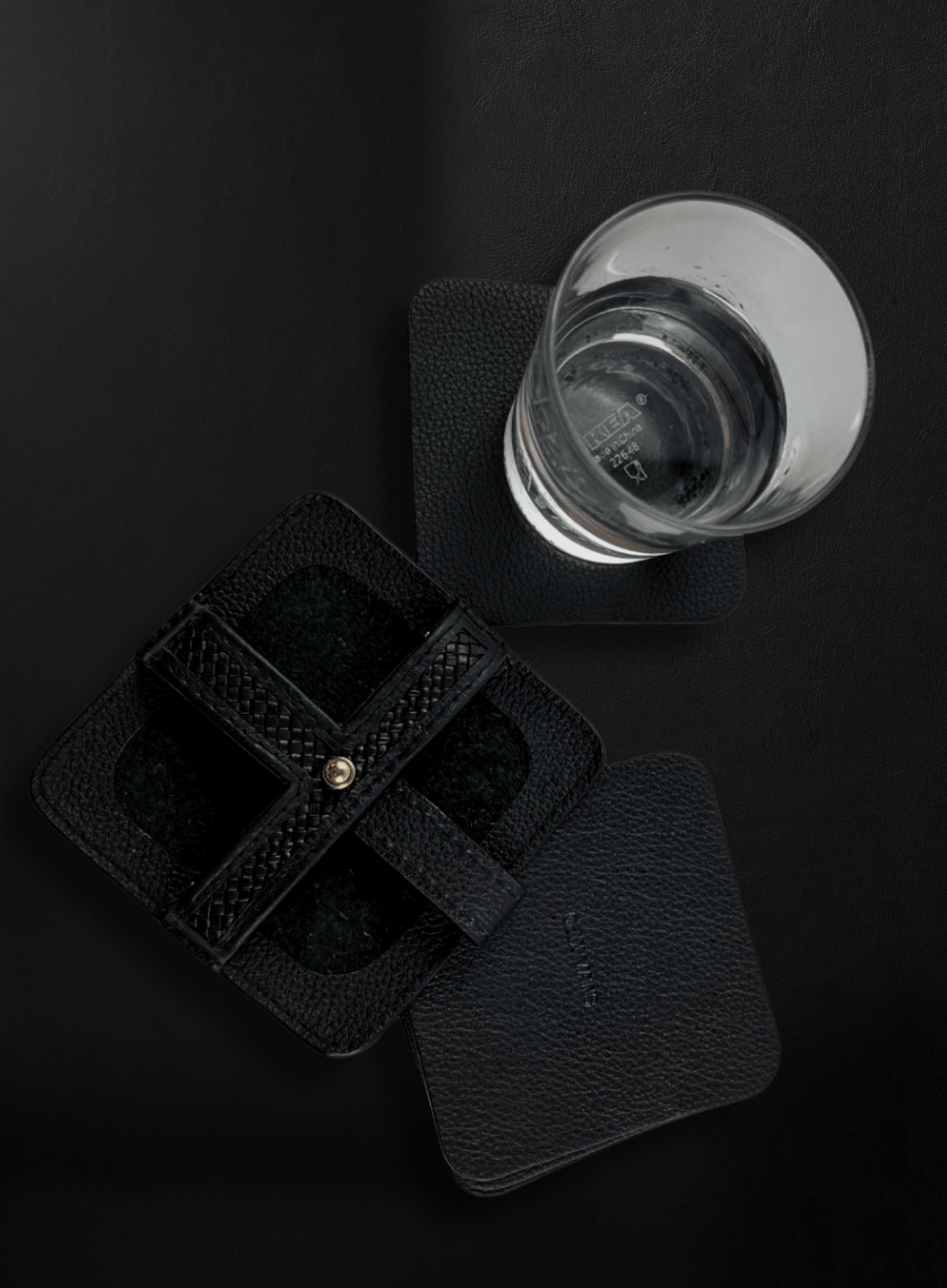 Cognac woven leather coasters with glass flat lay